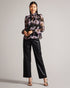 THEERA-Tops-Introducing the stunning THEERA blouse, a masterpiece of texture and print. Its textured fabric and photographic floral print are a feast for the eyes, while the stand collar with a keyhole cut-out add a touch of intrigue. With button fastening and delicate ladder lace inserts, this blouse will capture attention wherever you go. Textured blouse Photographic floral print Stand collar with keyhole cut-out Button fastening Ladder lace inserts Blouson sleeves Lined body- Ted Baker Romania